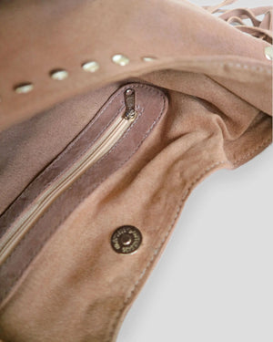 Close-up of a brown leather handbag with gold zipper and amazing decorative stud.