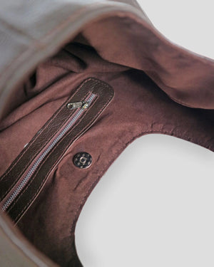 Close-up of a brown leather bag with a zipper in canada