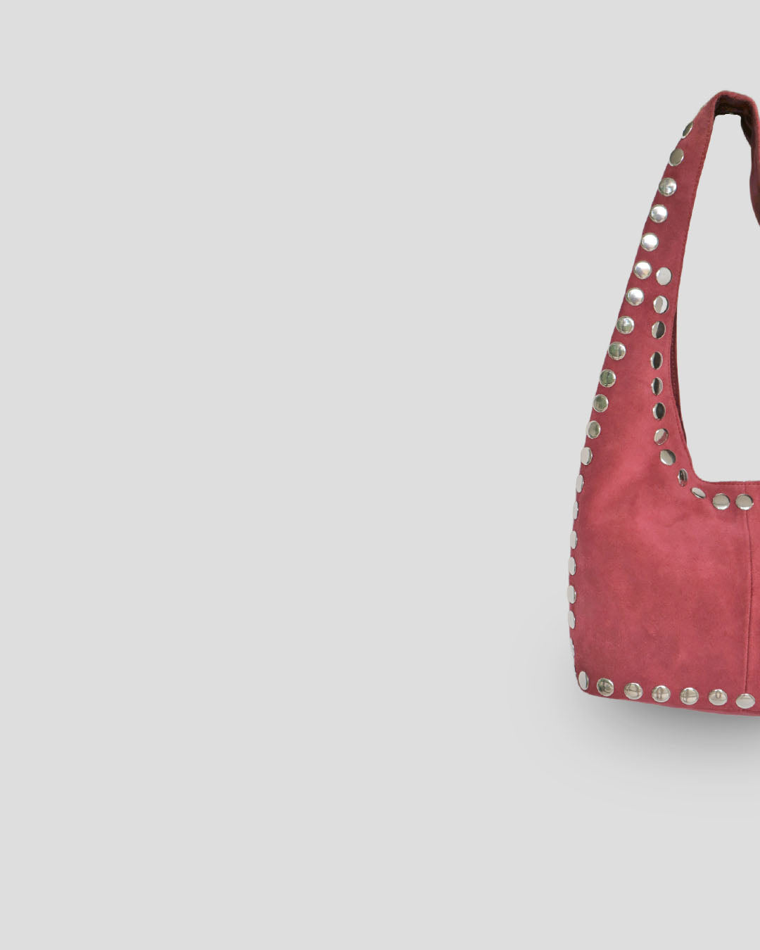 Pink handbag with studded details on a light gray background