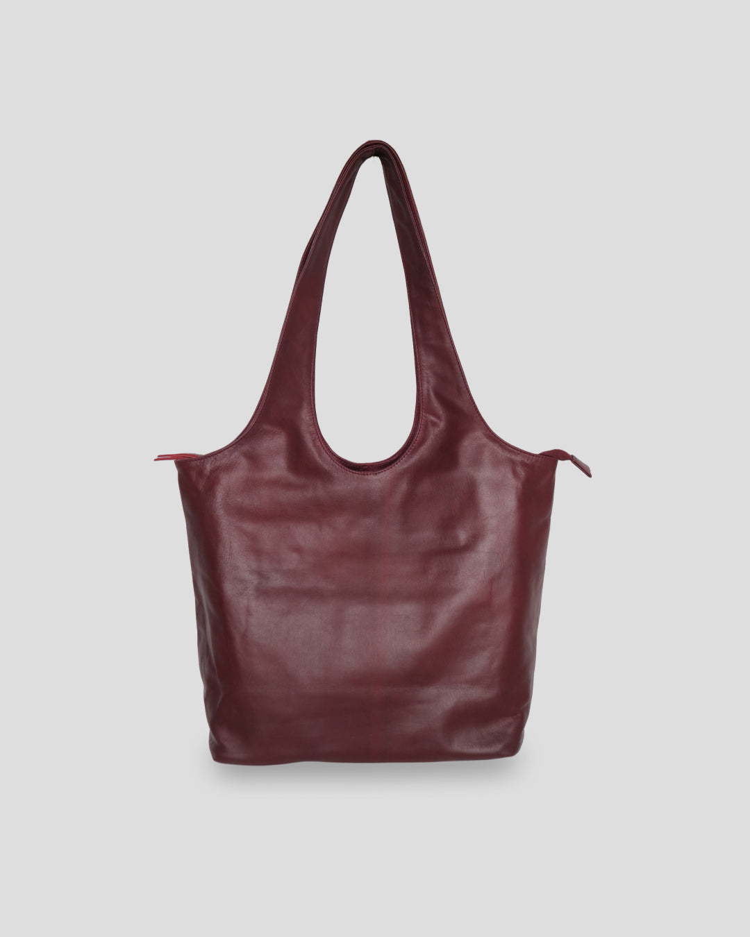 A maroon Ani Bag from bali with a smooth texture, featuring a shoulder strap