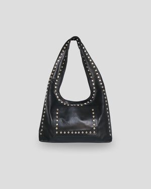 Black leather handbag with studs on a light gray background