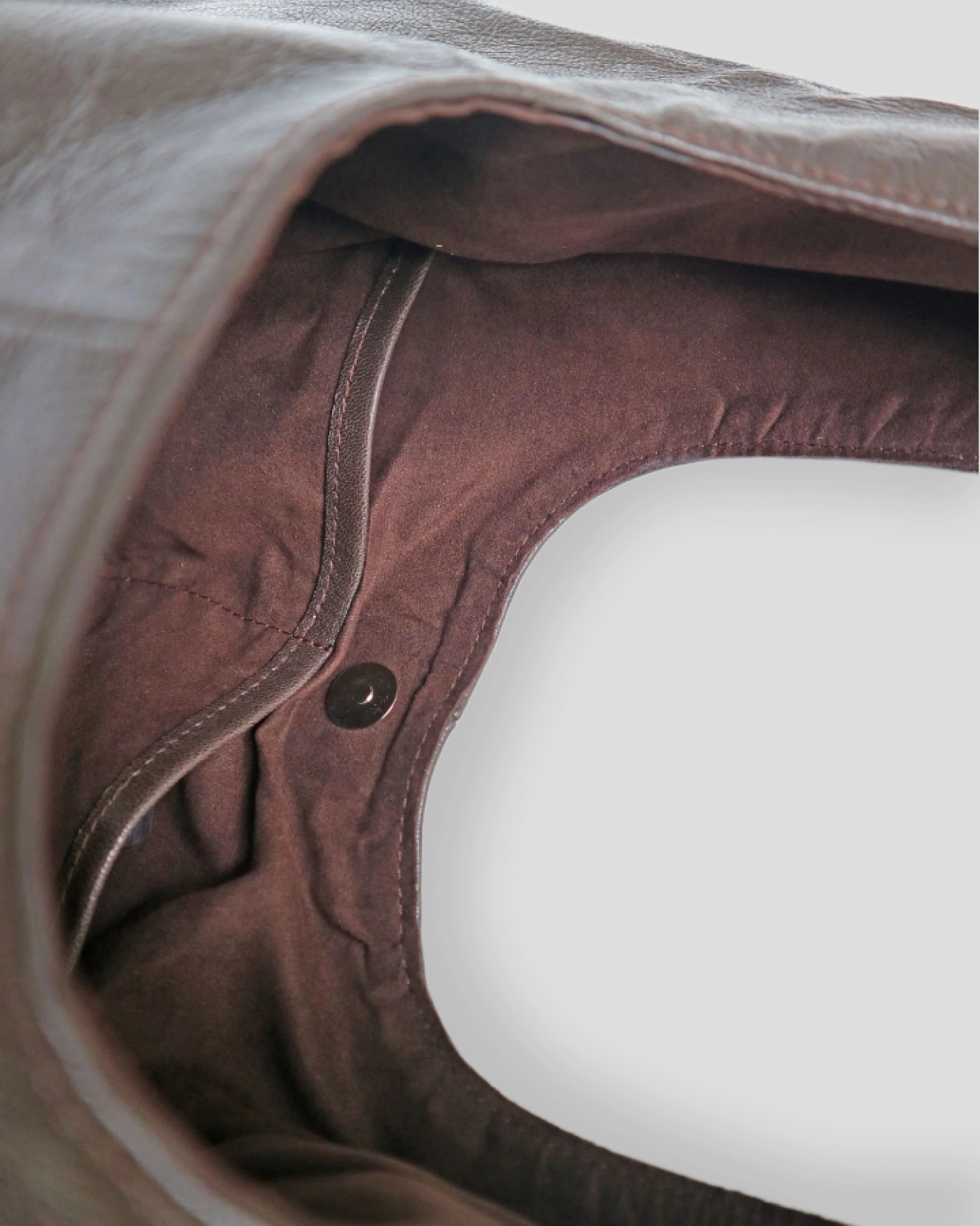 Pouch Close-up of a brown leather product with a button