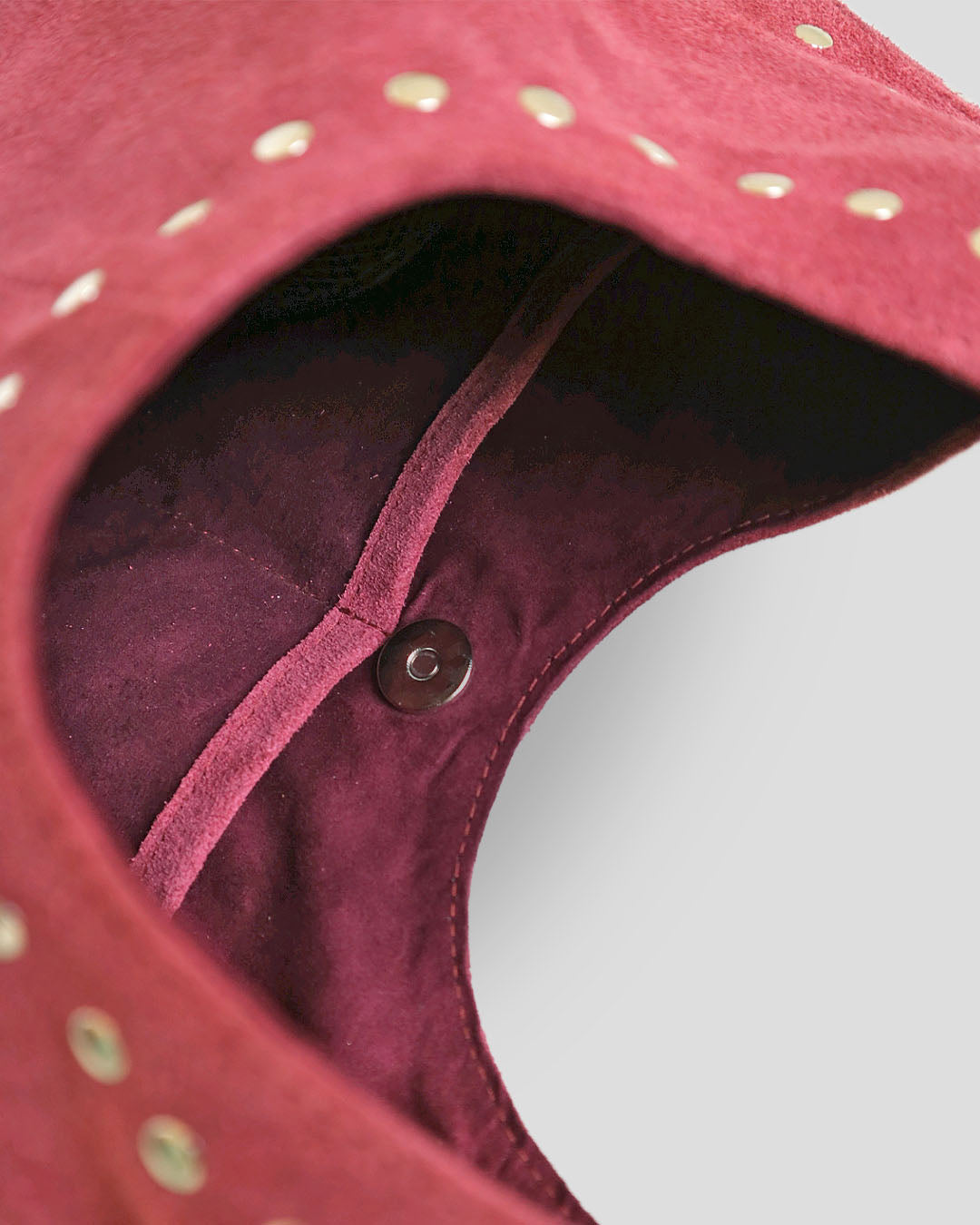 Navya suede shoulder bag interior showing magnetic closure and compartments with suede lining
