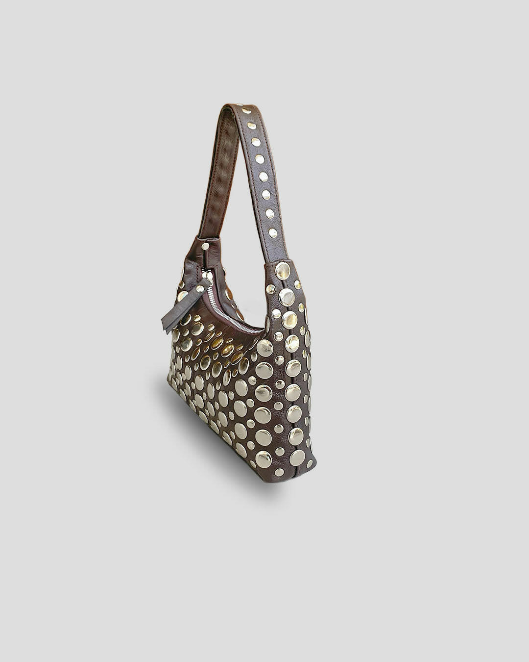 Studded handbag on a light gray background