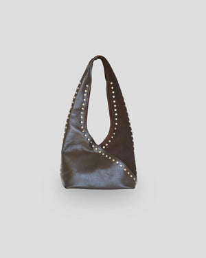 Brown mariposa leather handbag with studs on a light gray background