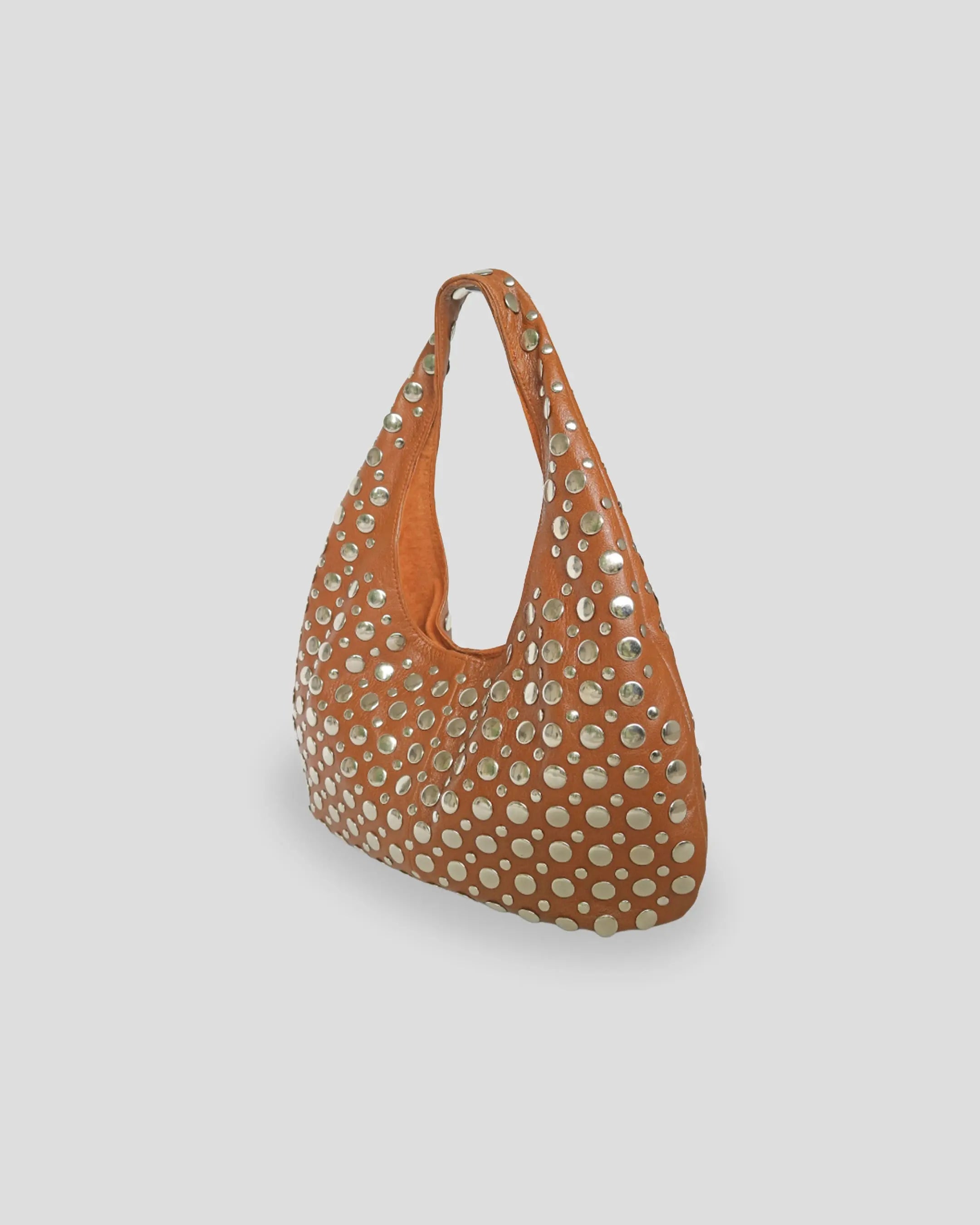 Full view of studded shoulder bag for women displaying unique tan color and comfortable strap design