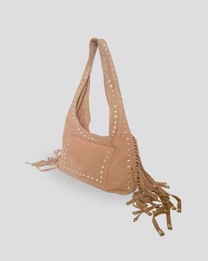 Tan suede handbag with fringe and studs on a professional studio photo